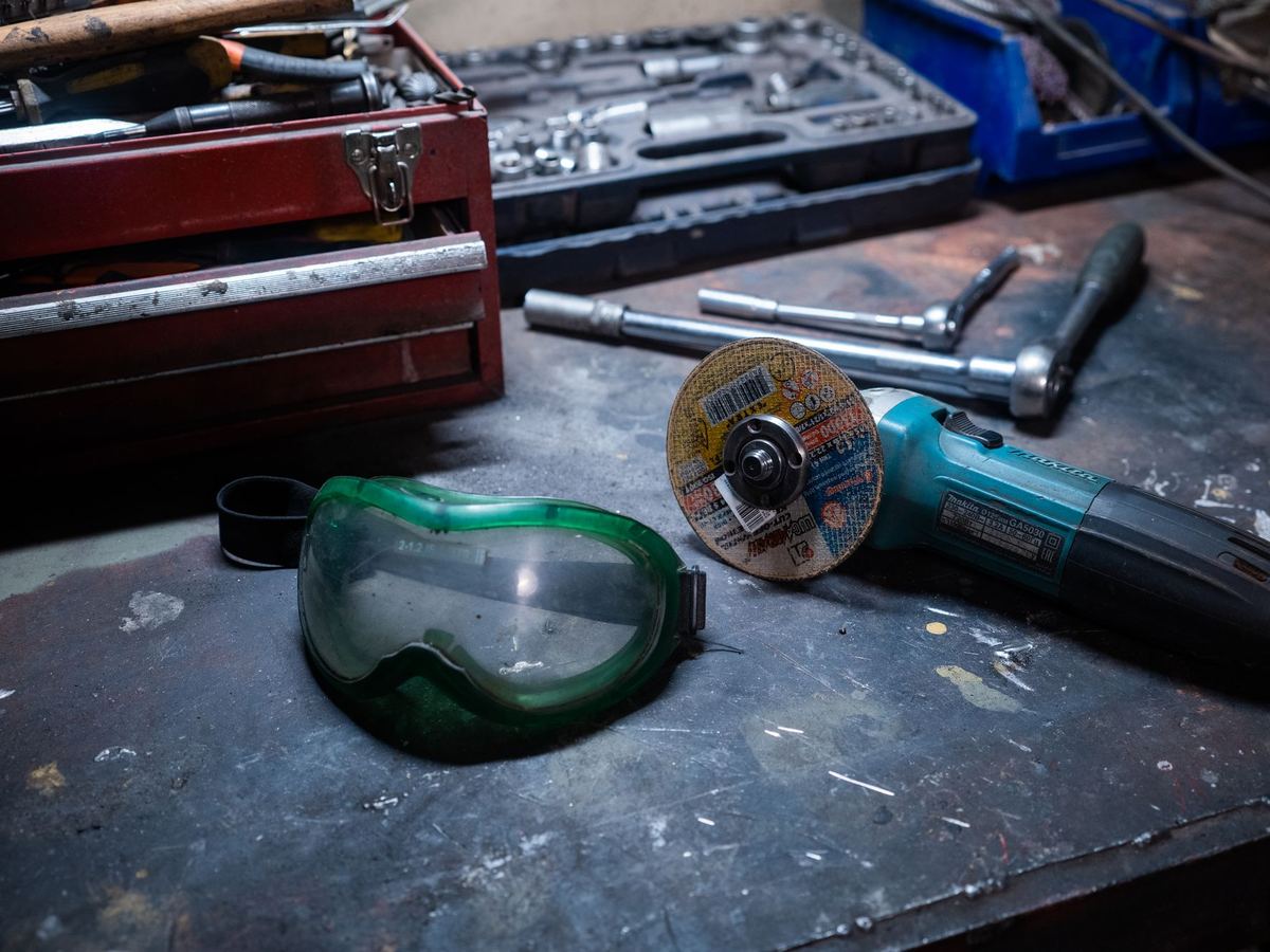 Tools and safety glasses on a workshop bench